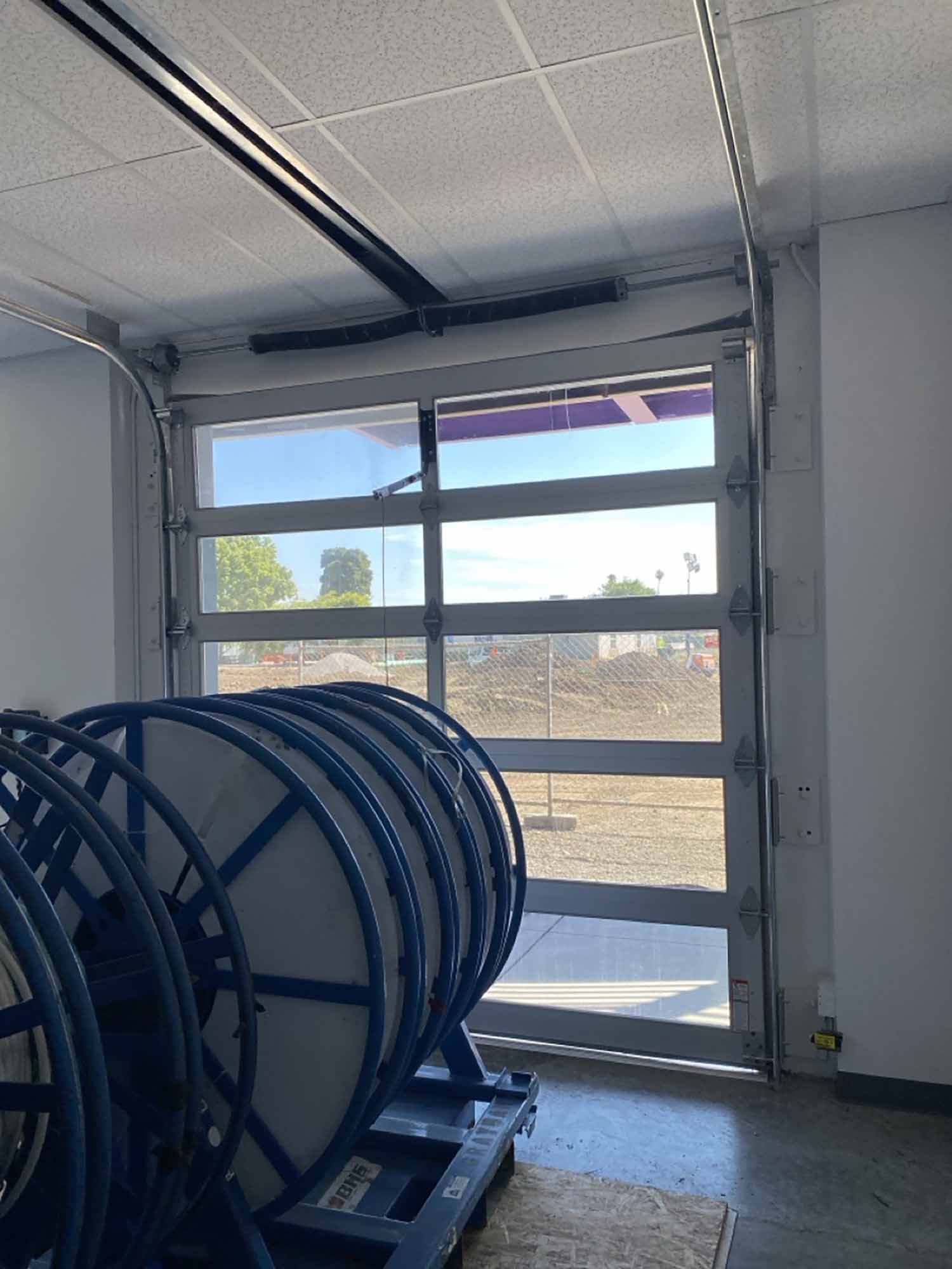 Interior view of a Hayward school rol up door featuring 3M Night Vision tinted windows.