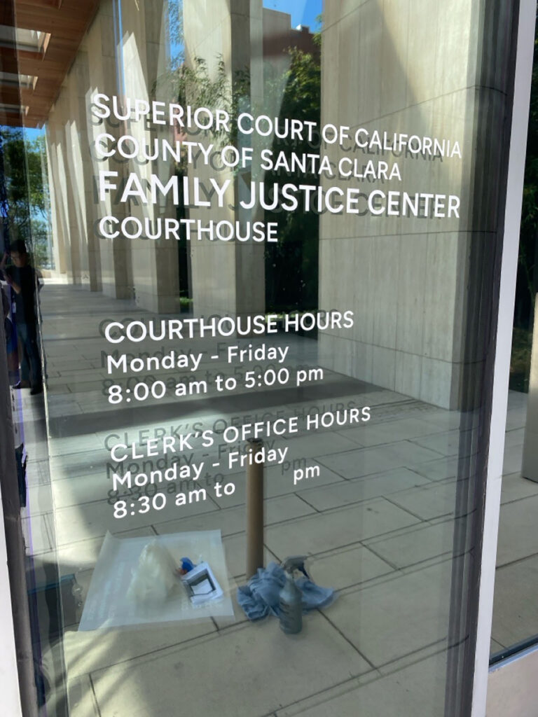 Because the new security film darkened the lower glazing, ClimatePro removed the interior courthouse hours graphic and installed a matching exterior graphic for improved visibility.