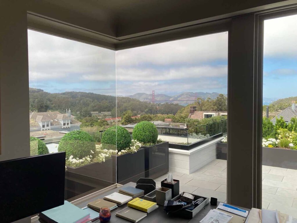 This office now enjoys greater comfort, reduced glare, and protection from harmful UV rays, all while maintaining the home's elegant appearance and expansive views.