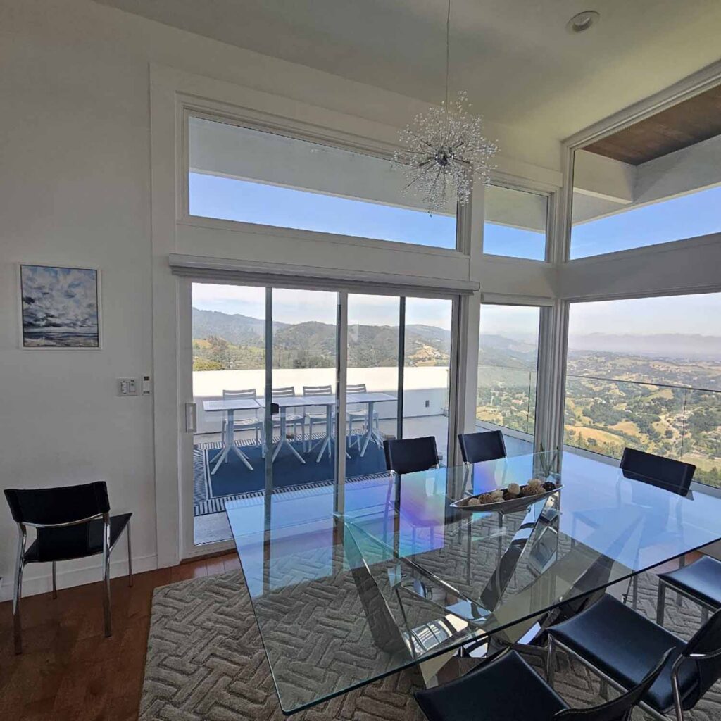 ClimatePro installed 3M Prestige 70 Exterior on six living room window panels and four glass doors for consistent solar control across the home's largest areas of glass.