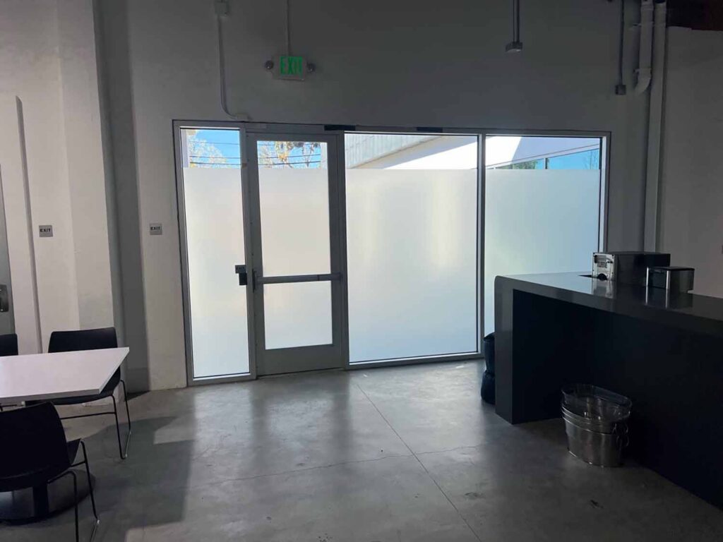 The entry door received matching frosted privacy film to create a consistent appearance throughout the office and improve privacy at the building entrance.