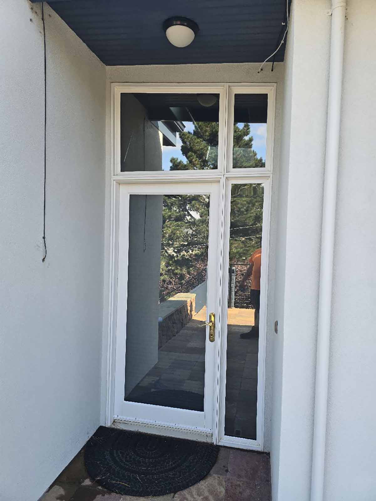 Solar-control film on the home's entry doors helps manage sunlight and UV exposure without replacing the existing glass.