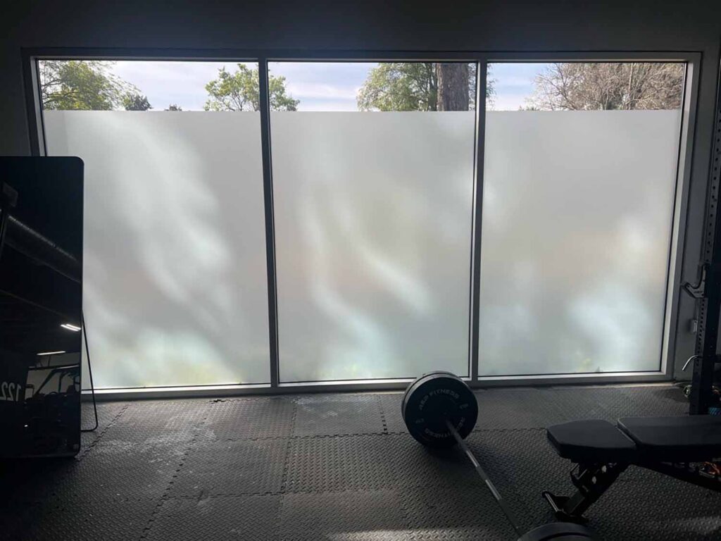 Privacy window film transformed this fitness room into a more welcoming employee amenity, helping staff exercise without feeling visible from outside the building.