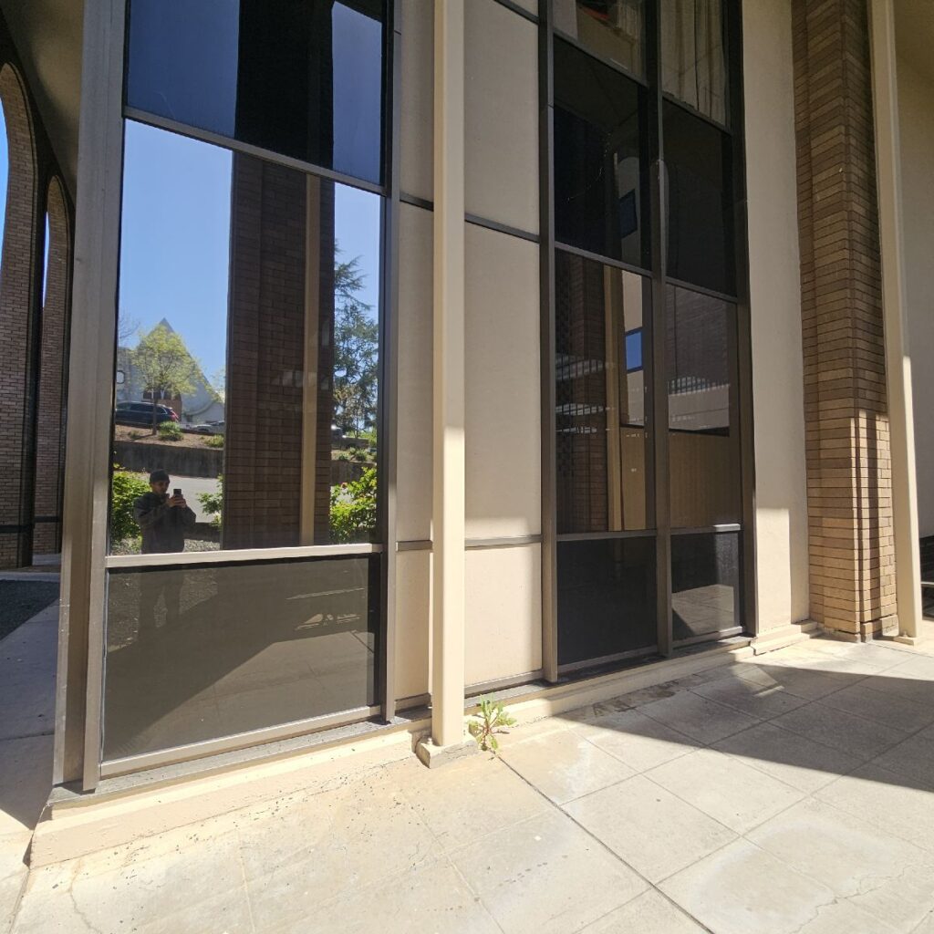 The finished installation helps reduce glare, solar heat, and UV exposure while giving the courthouse windows a consistent reflective finish.